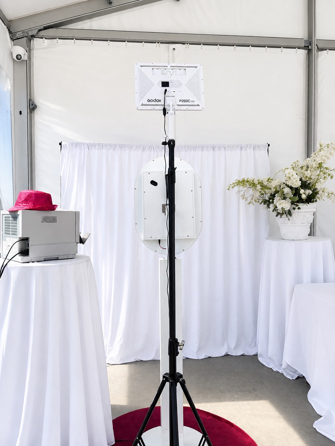 White photobooth setup with lighting in a bright event space